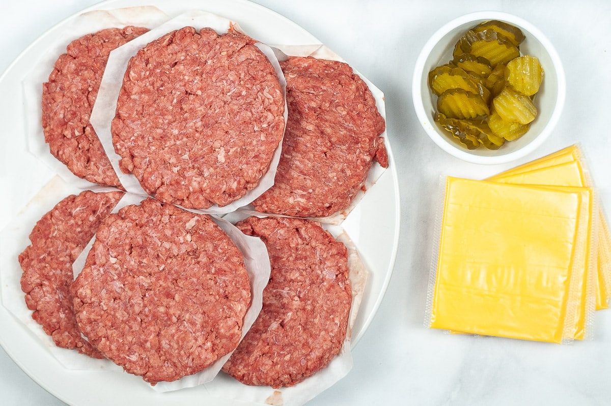 stacks of raw patties, pickle chips, and cheese slices for instant pot burgers