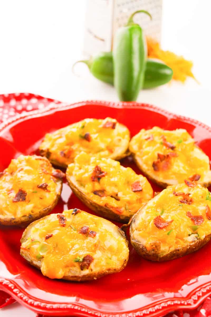 complete loaded twice baked potatoes sitting on red plate