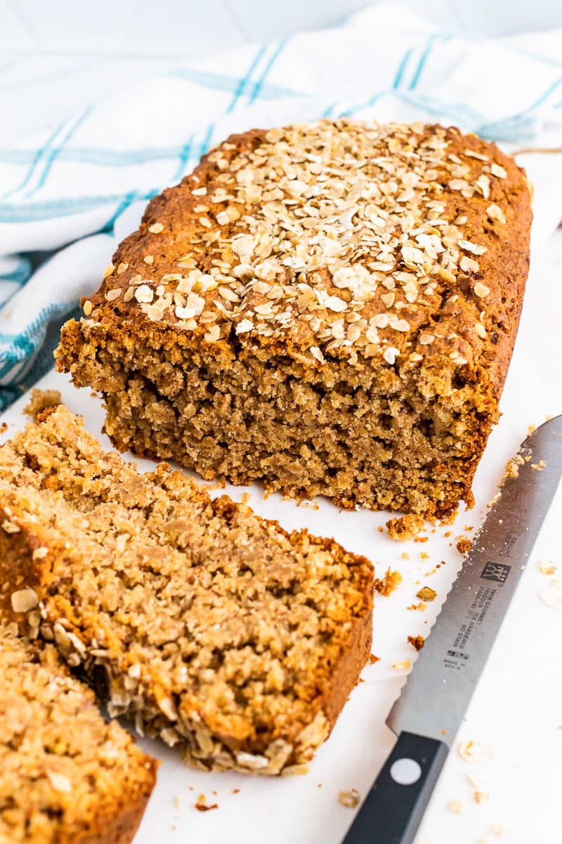 loaf of banana oat bread with a few slices cut out of it