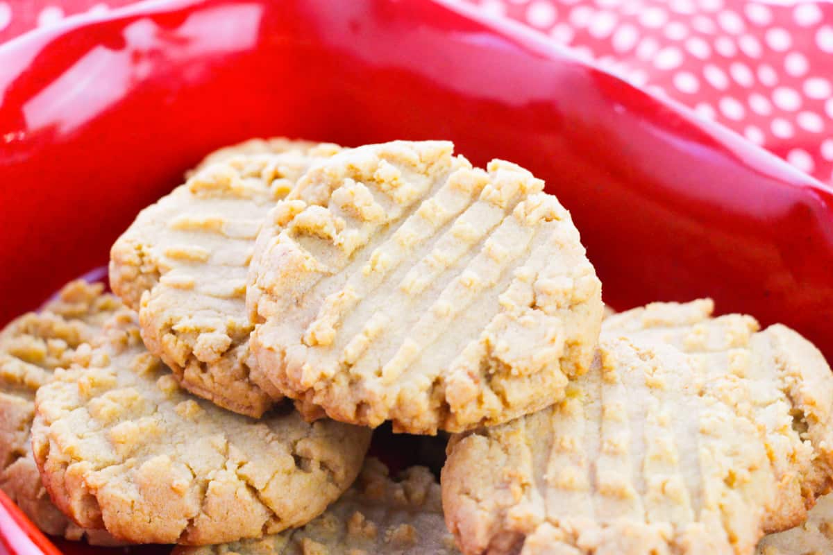 side view of old-fashioned peanut butter cookies on red plate
