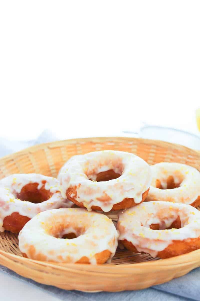 wicker bowl full of easy biscuit donuts covered in glaze