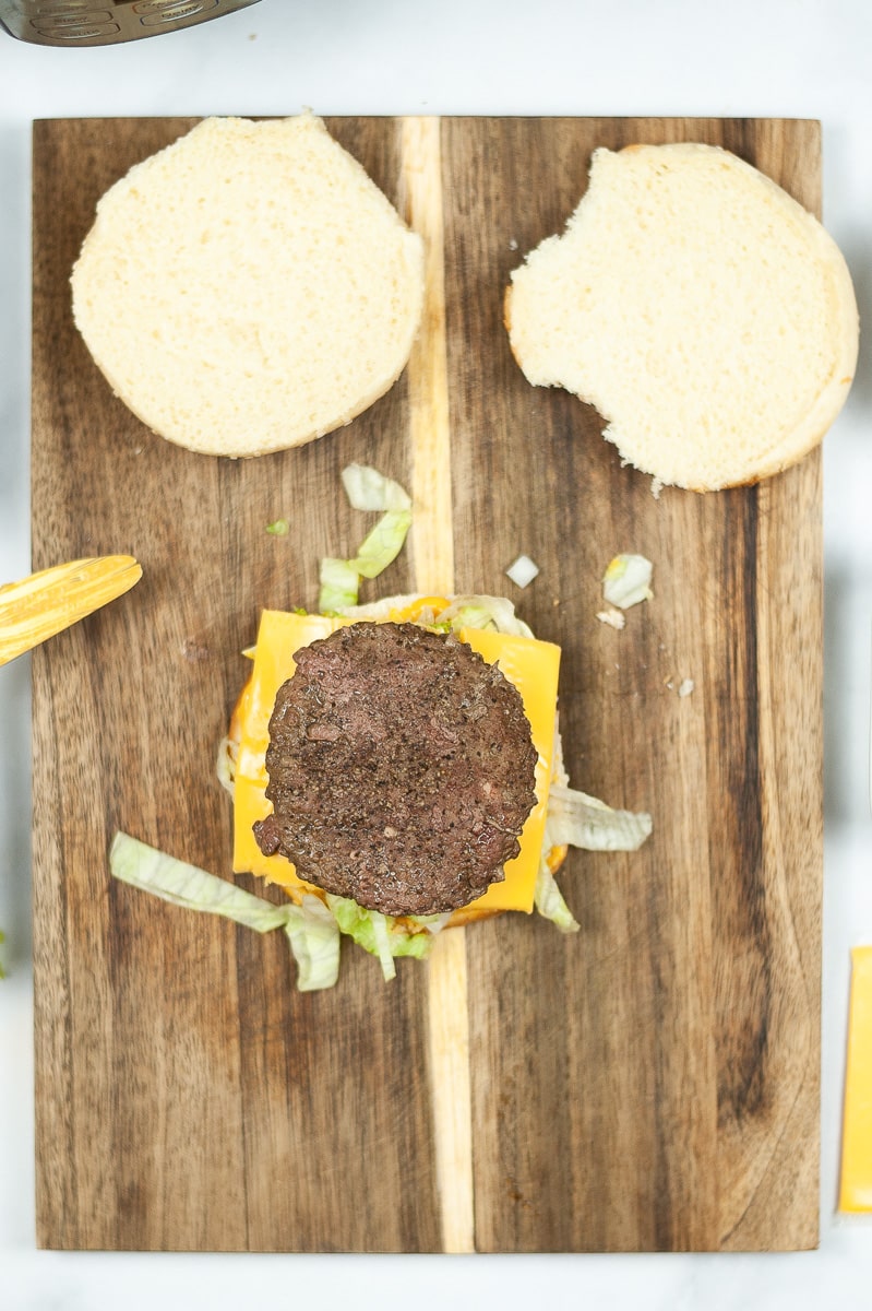 copycat Big Mac on wooden cutting board without top bun