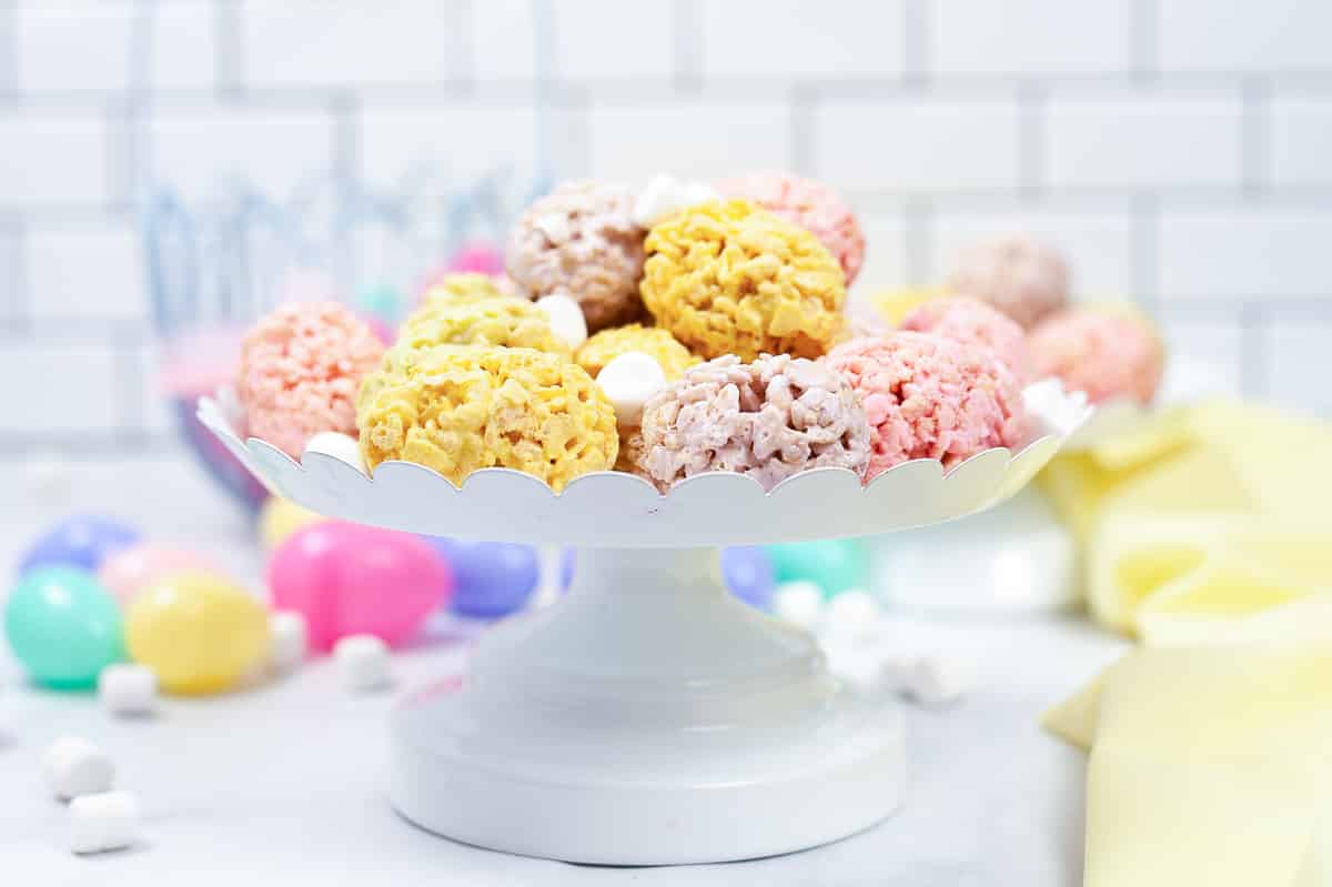 side view of white serving tray full of easter rice krispie treats sprinkled with white mini marshmallows