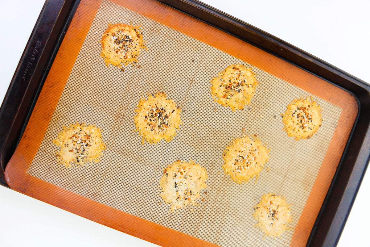 eight easy keto cheese crisps on lined baking sheet