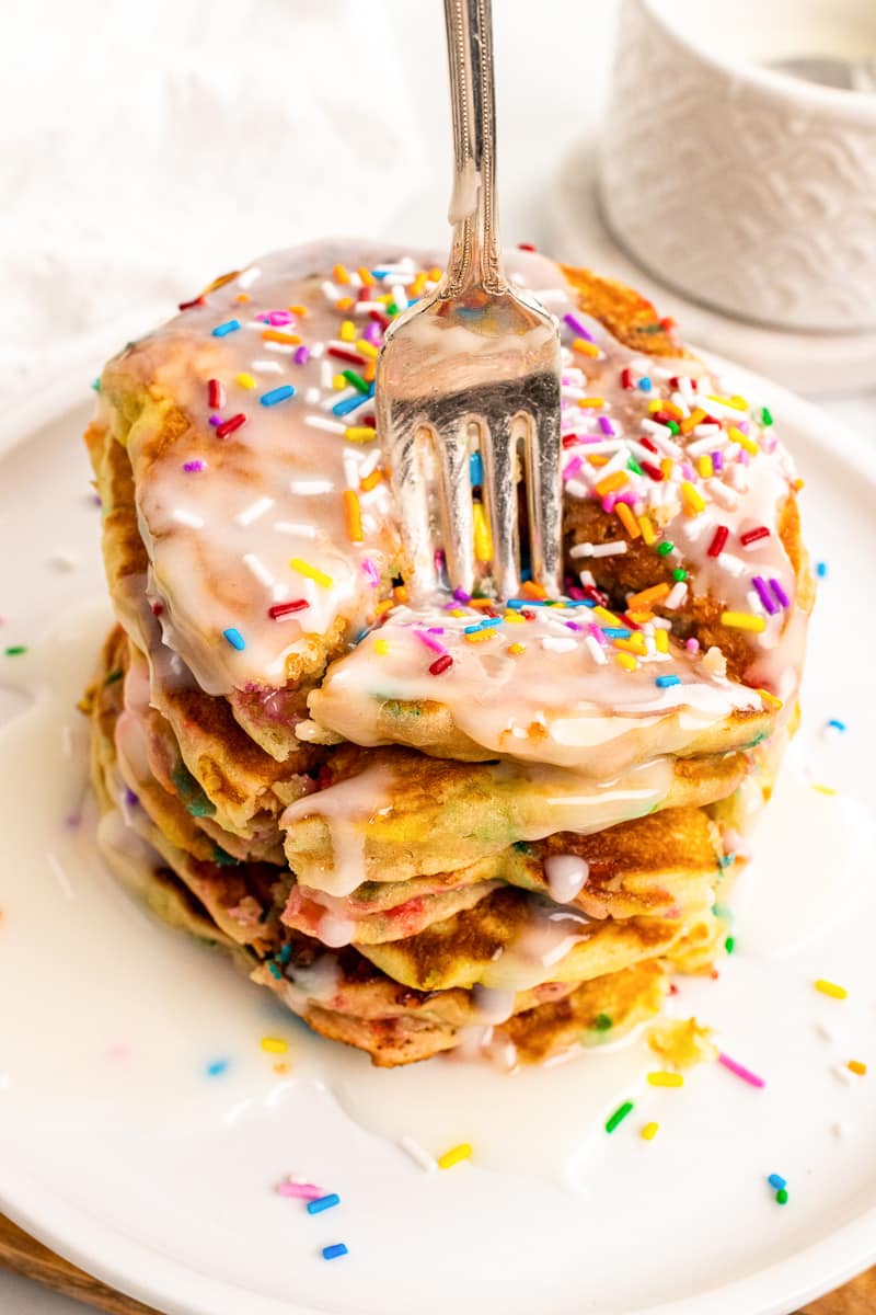 closeup of silver fork digging into a stack of funfetti pancakes