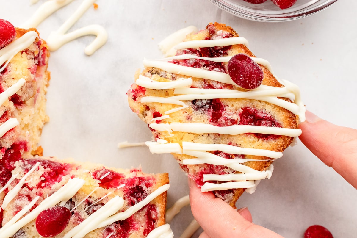 hand holding a lemon cranberry square