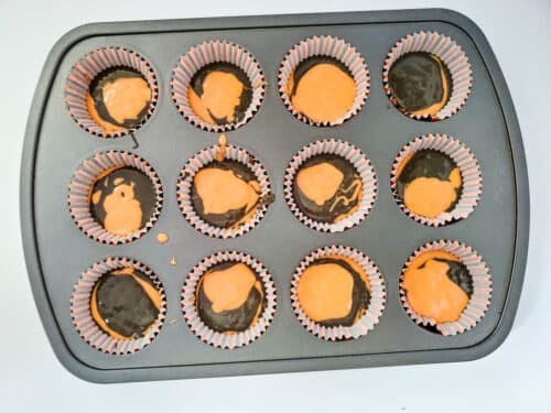 tie-dye inspired orange and black cupcake