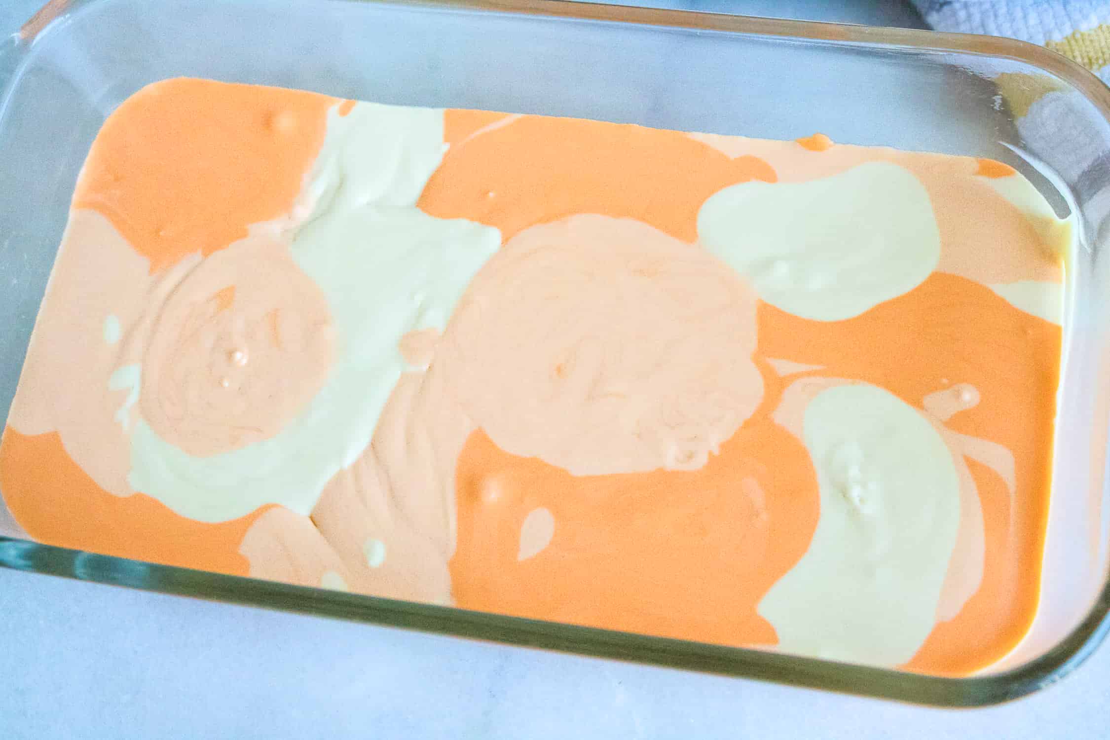 making the orange creamsicle ice cream in a large dish