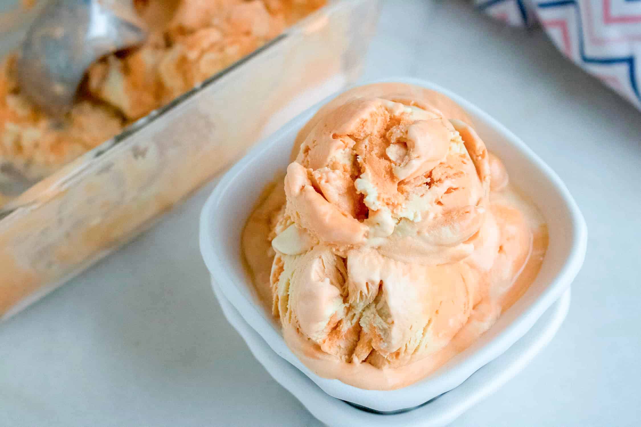 orange creamsicle ice cream in a white bowl