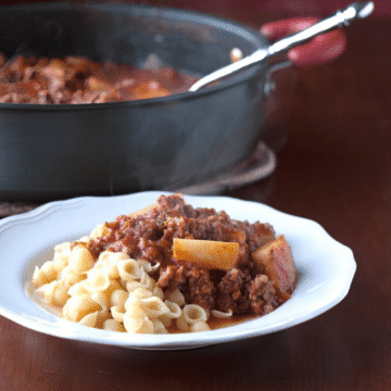 The best goulash ever with beef, sausage and potatoes over pasta shells