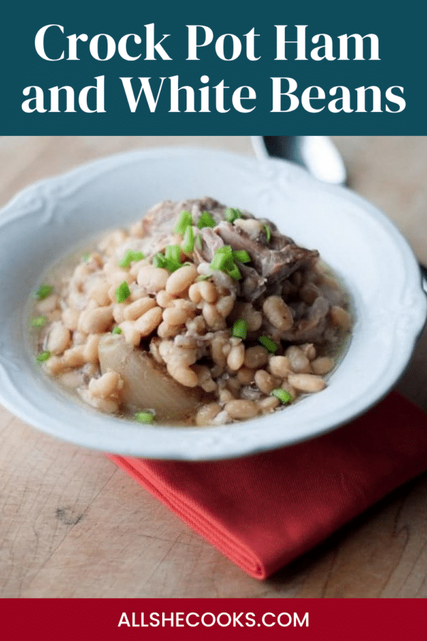 Crock Pot Ham and White Beans Pinterest graphic showing a bowl of navy beans and ham on a red napkin