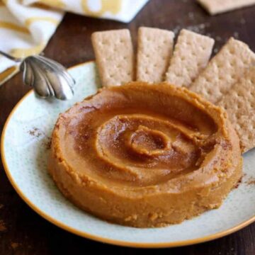 Dessert pumpkin hummus swirled on a plate with graham crackers