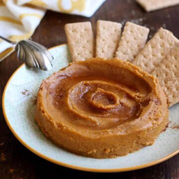 Dessert pumpkin hummus swirled on a plate with graham crackers