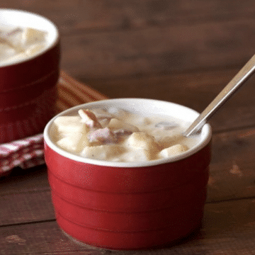 Easy ham and potato soup with heavy cream in a red ramekin