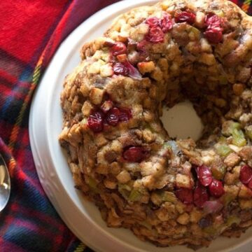 Fresh cranberry stuffing baked in a bundt pan, square crop showing cranberries and celery detail