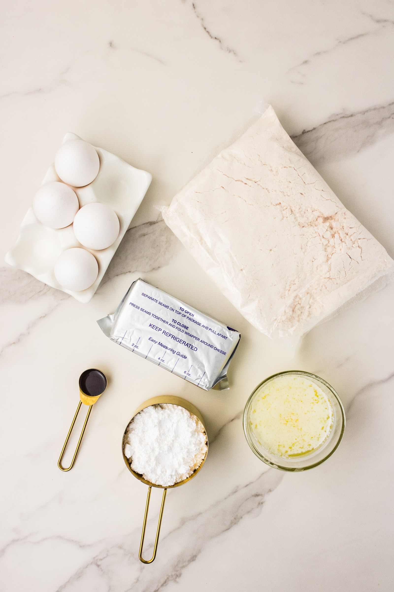 Ingredients for Neiman Marcus cake: yellow cake mix, eggs, cream cheese, melted butter, vanilla and powdered sugar