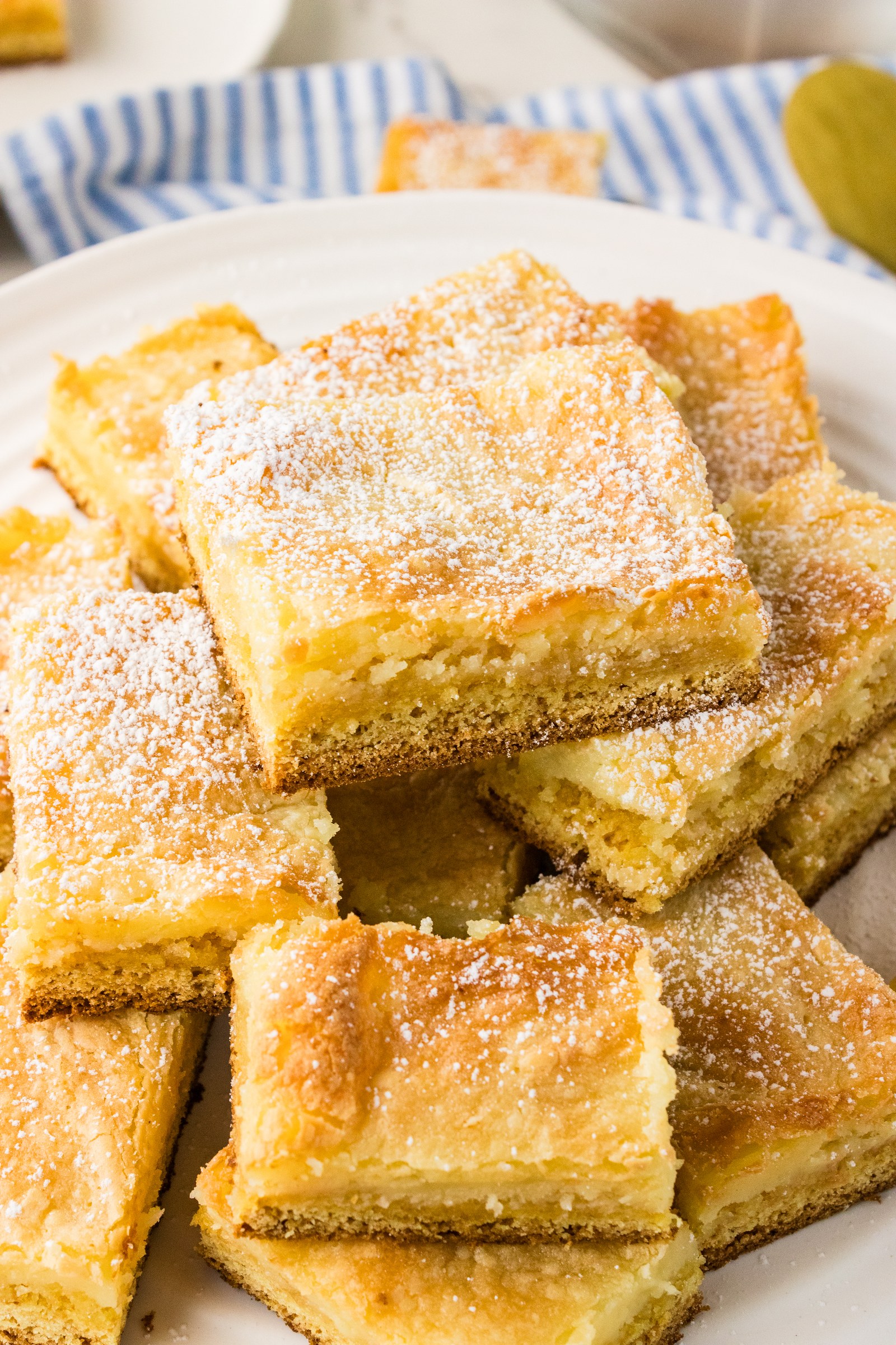 Platter piled with squares of Neiman Marcus cake dusted with powdered sugar