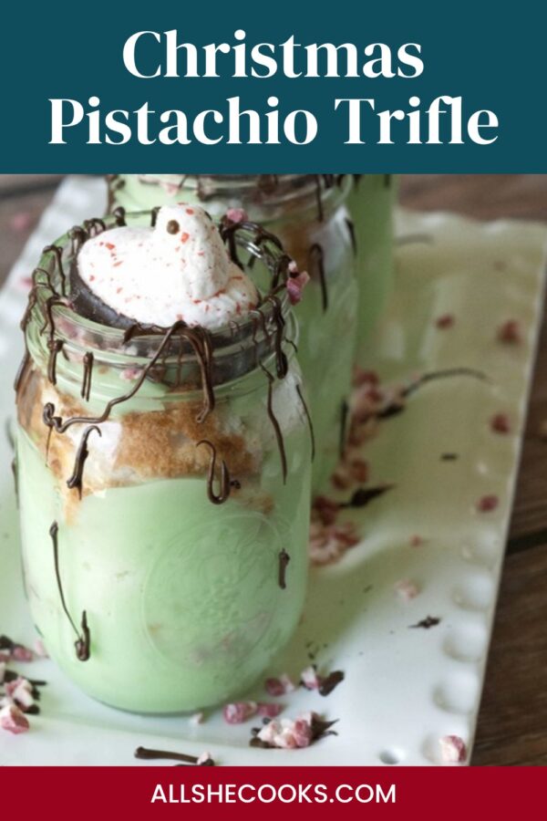 Christmas pistachio trifle pin: layered pistachio pudding trifle in a mason jar topped with a candy cane Peep