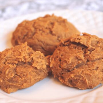 Three soft pumpkin breakfast cookies on a white plate