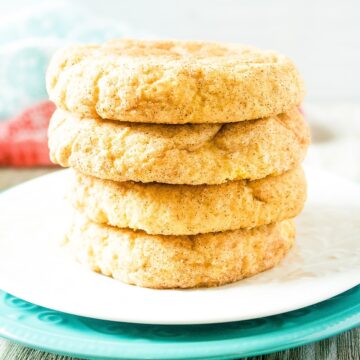Stack of four pumpkin snickerdoodle cookies on a white plate