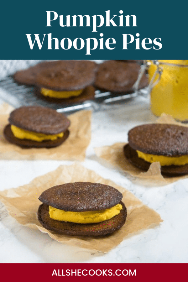Pumpkin Whoopie Pies Pinterest graphic - whoopie pies with pumpkin cream filling on parchment paper