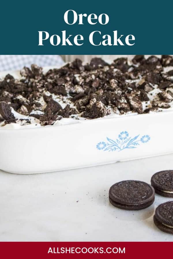 Oreo poke cake topped with crushed Oreos in a white baking dish with the text Oreo Poke Cake